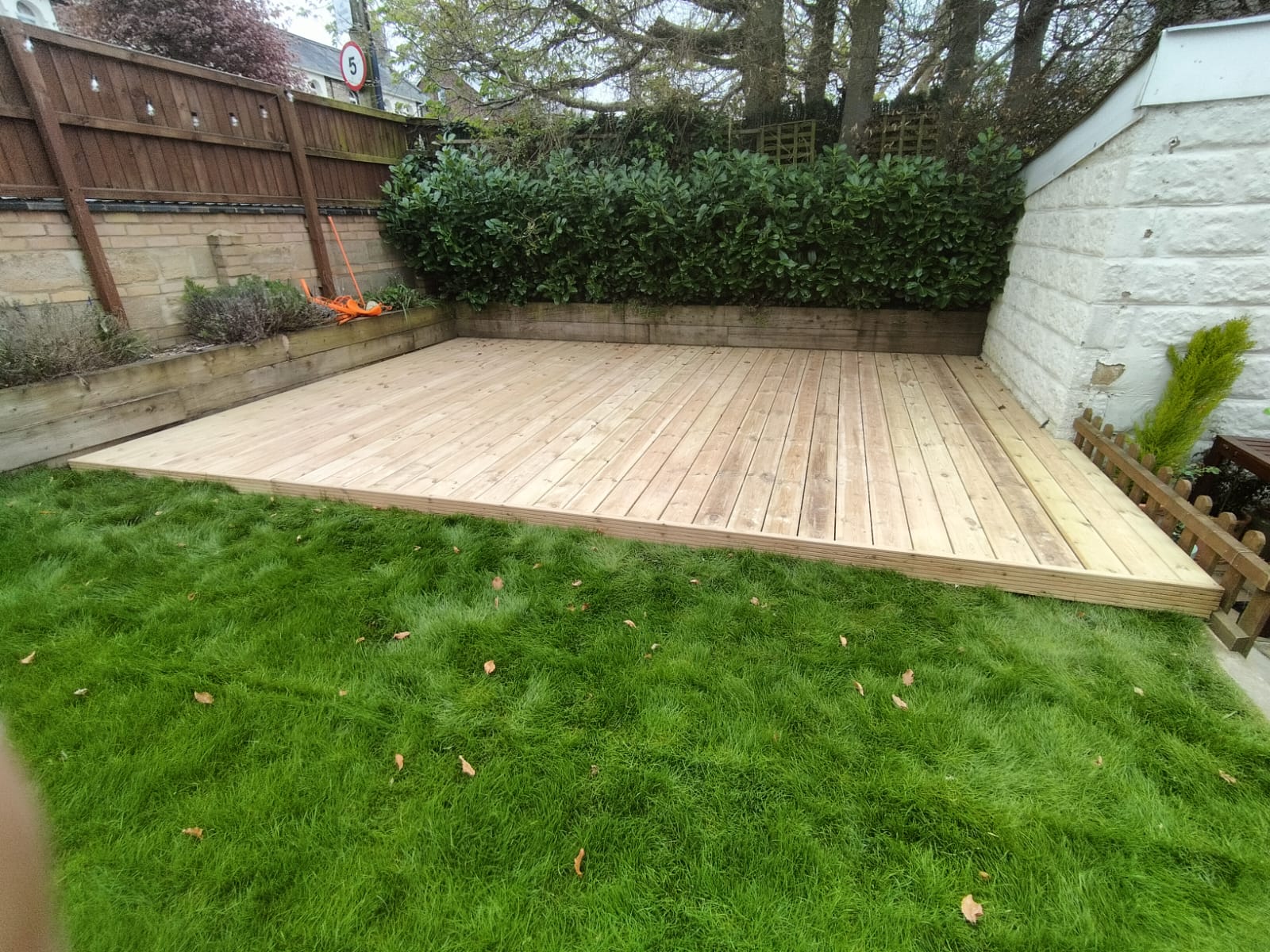 timber decking norwich installation with nice green grass in the foreground